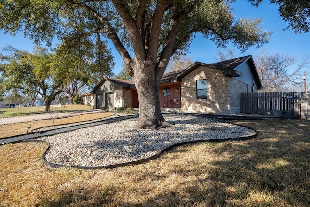 view of front of property with fence and brick siding