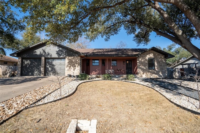 ranch-style house with a garage, driveway, and fence