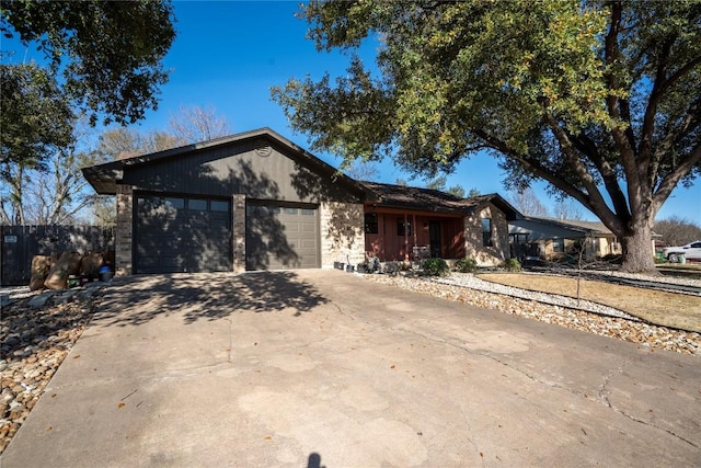 ranch-style house with driveway and a garage