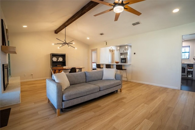 living room featuring baseboards, visible vents, vaulted ceiling with beams, and light wood-style floors