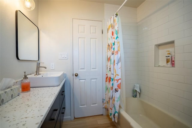 bathroom featuring shower / tub combo, wood finished floors, and vanity