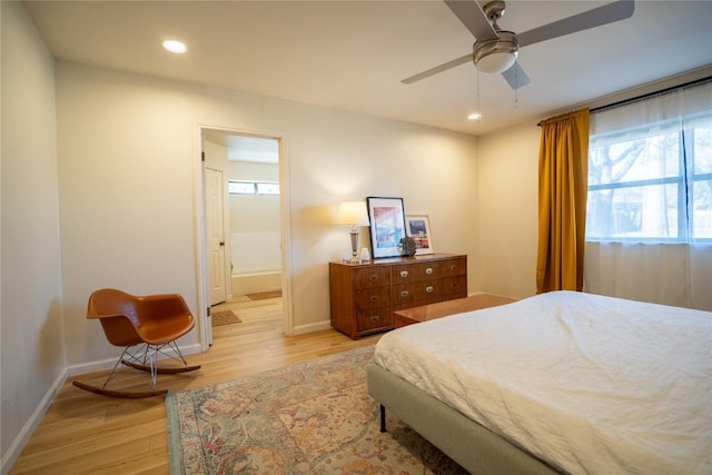 bedroom with recessed lighting, baseboards, light wood-style floors, and ensuite bath