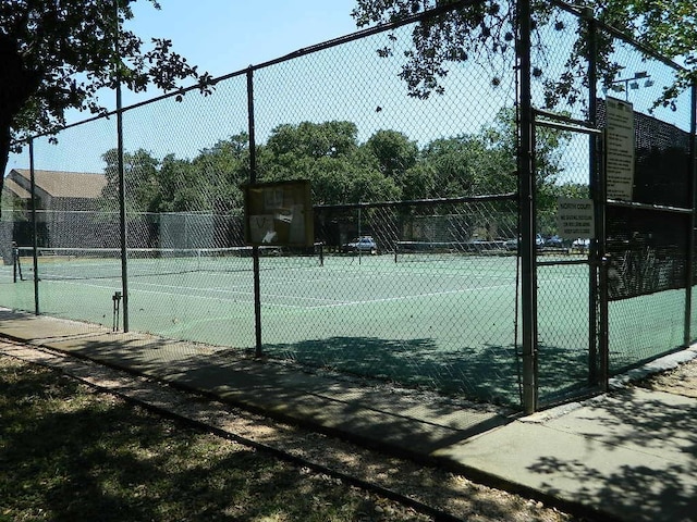 view of tennis court with fence