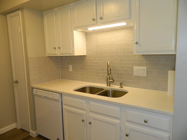 kitchen with dishwasher, tasteful backsplash, white cabinetry, and a sink