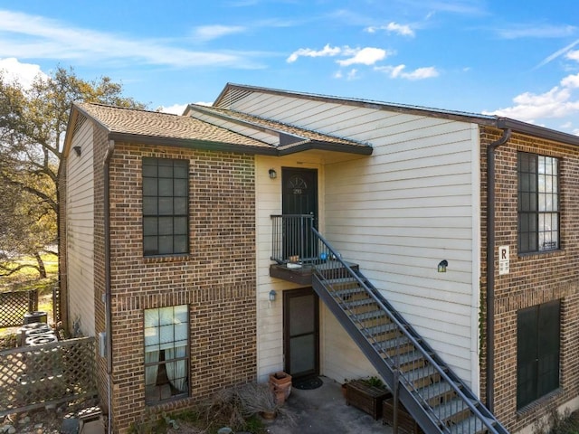 view of front of property featuring brick siding and fence