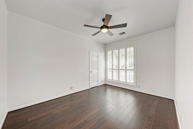 unfurnished room featuring dark wood finished floors, baseboards, and visible vents