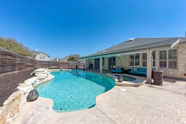 view of pool featuring a patio, a fenced backyard, a pool with connected hot tub, french doors, and an outdoor hangout area