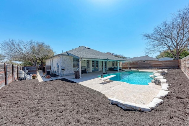 rear view of house featuring french doors, a patio, and a fenced backyard