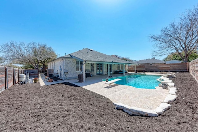 1000 Rutgers Dr, Pflugerville, TX 78660 - view of pool with french doors, a diving board, a patio, and a fenced backyard