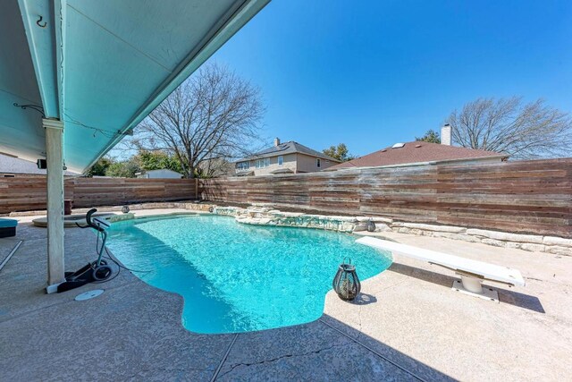 1000 Rutgers Dr, Pflugerville, TX 78660 - view of swimming pool with a diving board and a fenced backyard