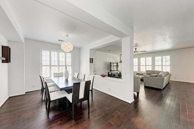 dining space with a ceiling fan, visible vents, baseboards, and dark wood-style flooring