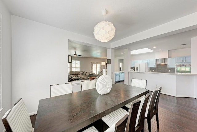 dining space with recessed lighting, dark wood-type flooring, and baseboards