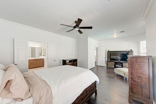 bedroom with visible vents, a textured ceiling, crown molding, and hardwood / wood-style flooring