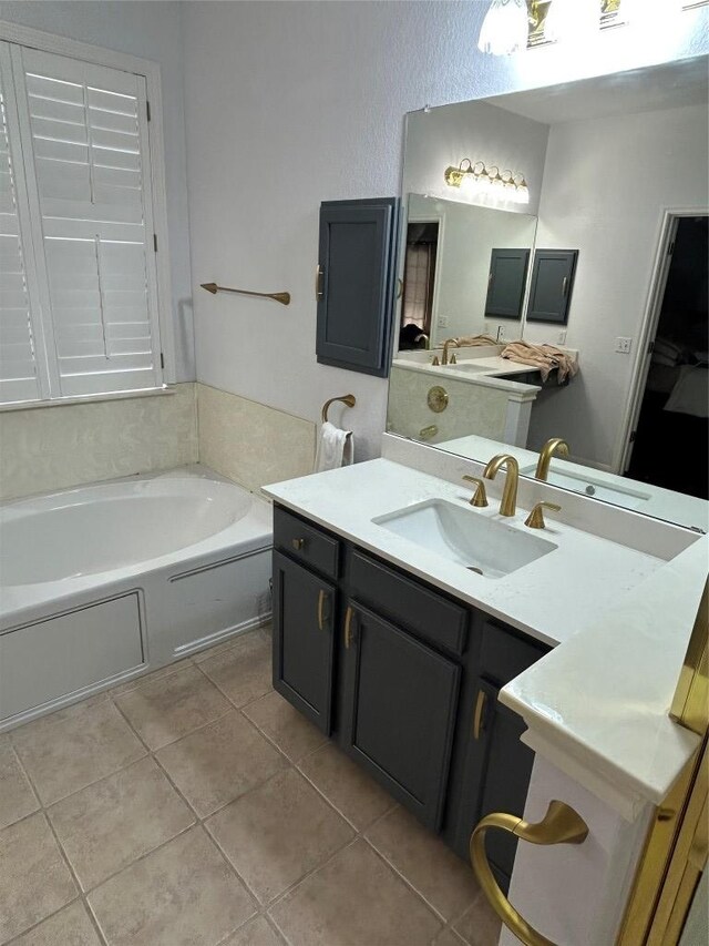 1000 Rutgers Dr, Pflugerville, TX 78660 - bathroom with tile patterned floors, a garden tub, and vanity