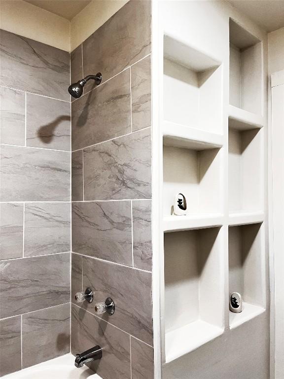 interior details featuring shower / tub combination