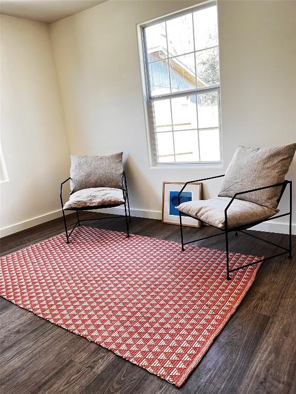 living area featuring dark wood finished floors and baseboards