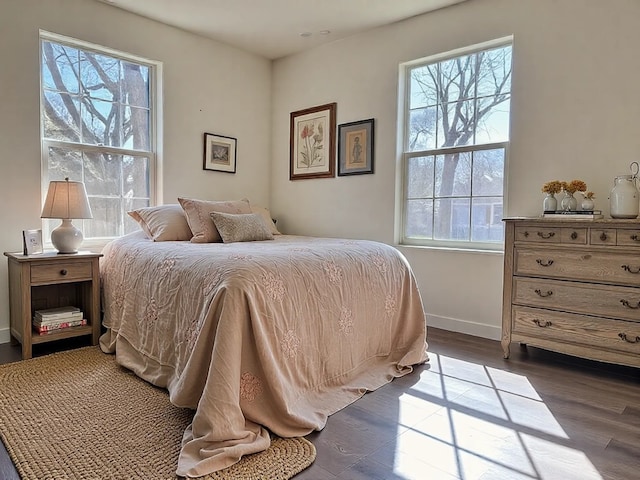 bedroom featuring dark wood-style floors and baseboards