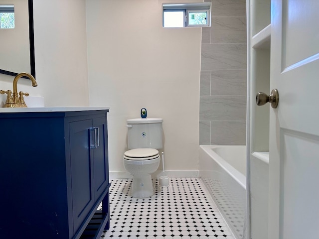 bathroom with vanity, toilet, baseboards, and tile patterned flooring
