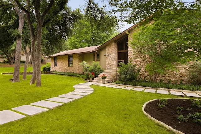 view of front of property with a front yard and stone siding