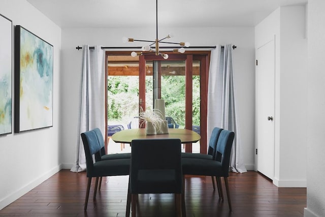 dining room featuring baseboards, an inviting chandelier, and dark wood-style floors