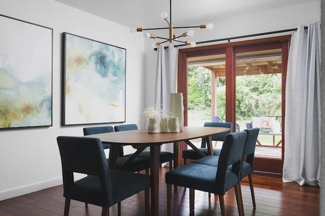 dining space featuring a notable chandelier, baseboards, and hardwood / wood-style floors