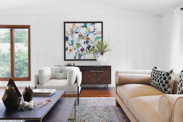 living room featuring lofted ceiling and wood finished floors