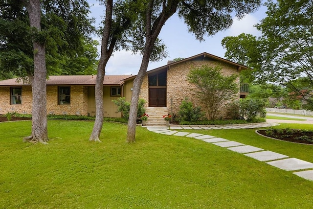 view of front of home with a front lawn, stone siding, and stucco siding