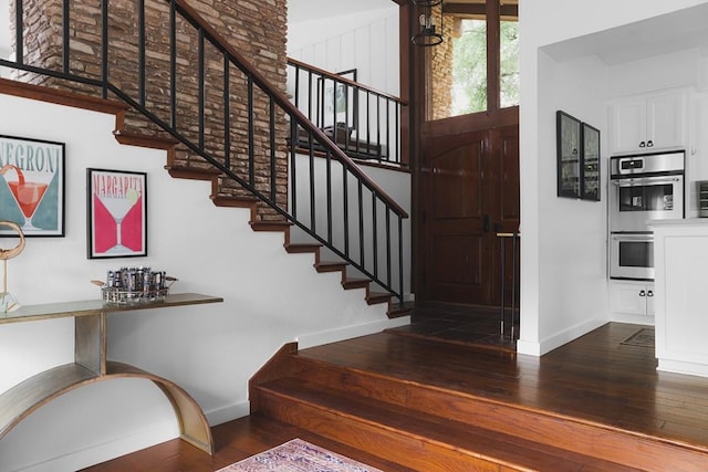 stairway with baseboards and wood-type flooring