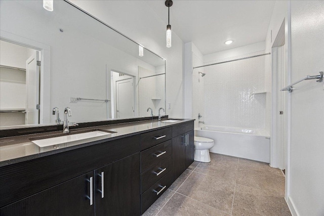 bathroom featuring a sink, washtub / shower combination, toilet, and double vanity