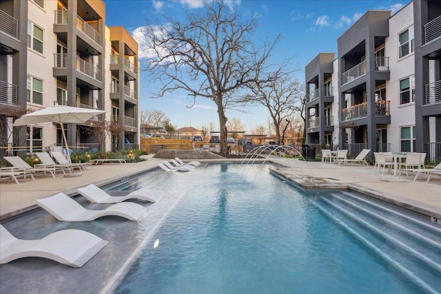 view of pool with a patio and fence