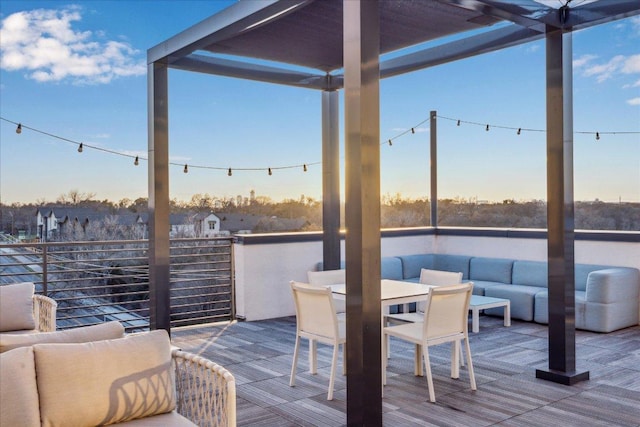 deck at dusk featuring outdoor lounge area and outdoor dining area