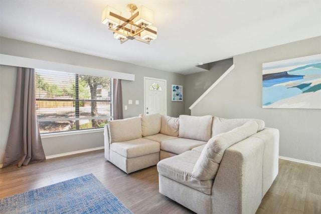 living area with baseboards and wood finished floors