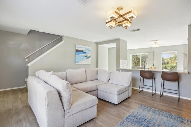 living area featuring wood finished floors, visible vents, and baseboards