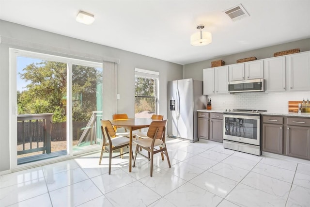 1505 Curameng Cv, Austin, TX 78748 - kitchen featuring stainless steel appliances, light marble finish floors, and decorative backsplash