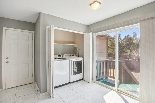 washroom featuring marble finish floor, laundry area, and washer and clothes dryer