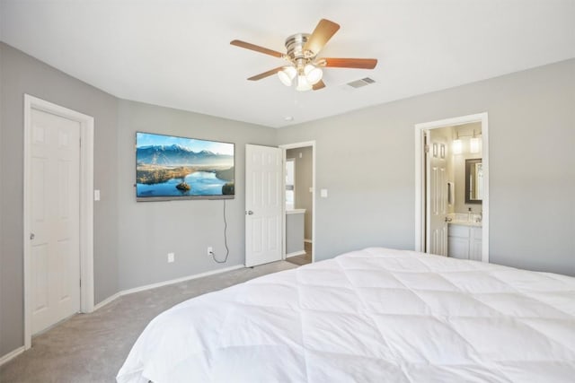 bedroom with baseboards, visible vents, attic access, carpet flooring, and connected bathroom