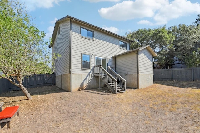 back of house featuring fence