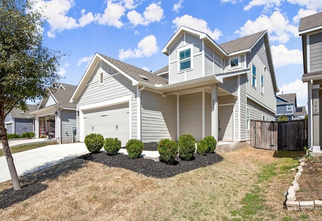 view of front of house featuring fence, a shingled roof, board and batten siding, and driveway