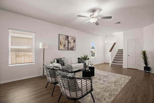 living area with dark wood-style flooring, ceiling fan, stairs, baseboards, and visible vents
