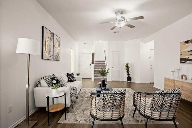 living room with visible vents, stairs, wood finished floors, baseboards, and ceiling fan