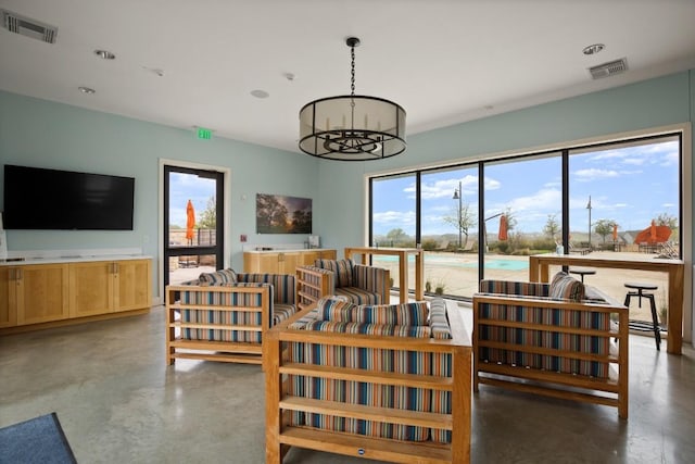 112 High Plains Pass, Liberty Hill, TX 78642 - living area with finished concrete floors, a chandelier, and recessed lighting