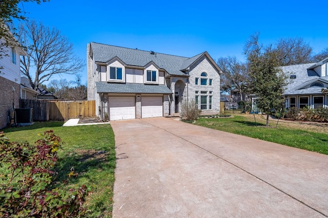 view of front of house with fence, concrete driveway, a front yard, central AC unit, and a garage