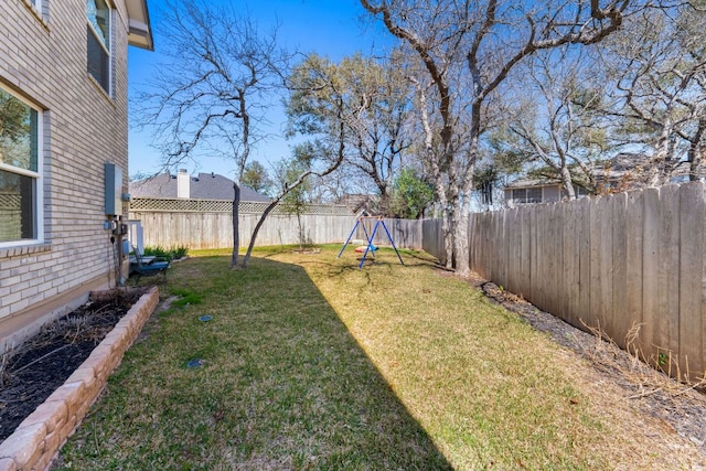 view of yard featuring a fenced backyard and a playground