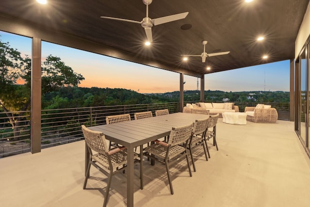 view of patio with outdoor dining area and a ceiling fan