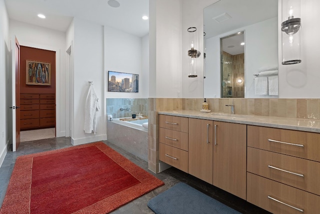 full bathroom with vanity, visible vents, baseboards, recessed lighting, and a garden tub