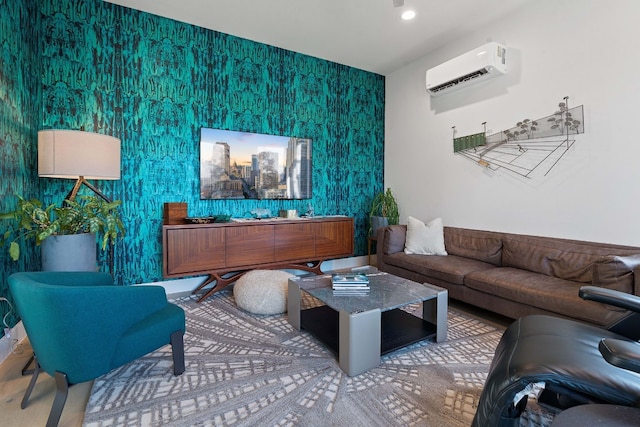 living area featuring wallpapered walls, a wall mounted AC, and an accent wall