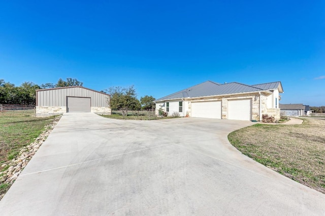 ranch-style house featuring fence, concrete driveway, a front lawn, and stone siding