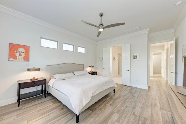 bedroom featuring visible vents, crown molding, light wood finished floors, and baseboards