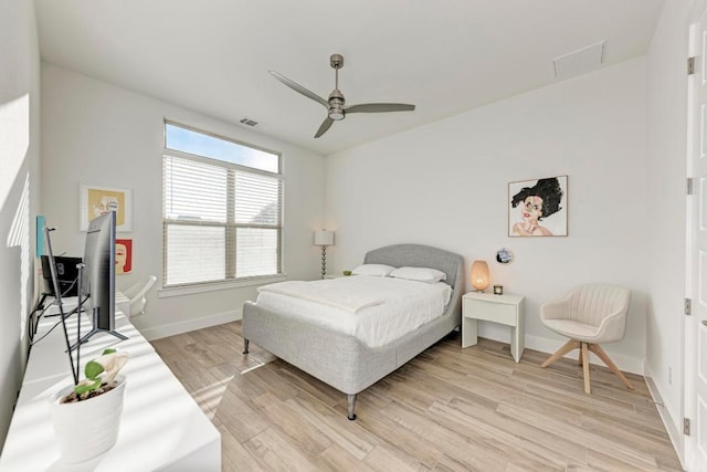 bedroom featuring visible vents, baseboards, ceiling fan, and light wood-type flooring