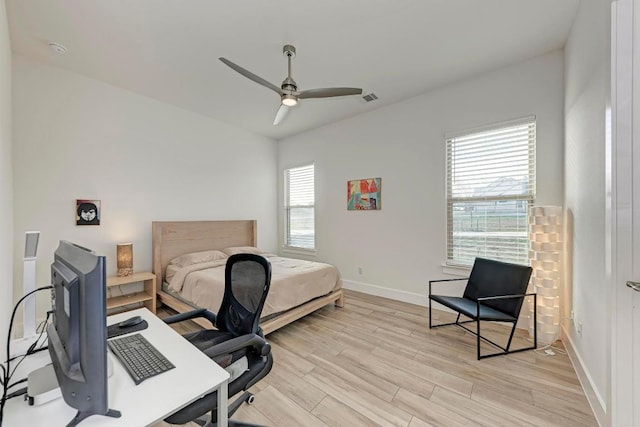 bedroom with baseboards, visible vents, ceiling fan, and light wood finished floors